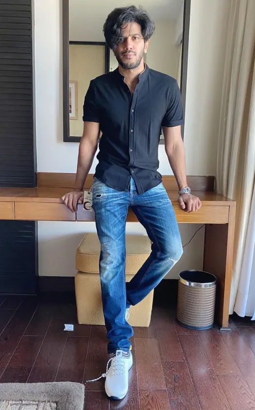 Outing outfit for men with black shirt blue jeans white shoes