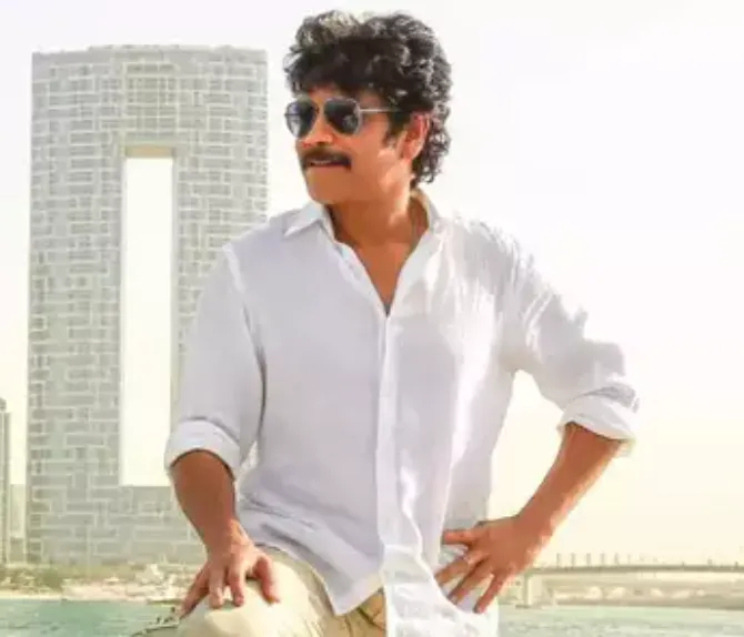 Nagarjuna in white shirt khaki pant blue sunglasses